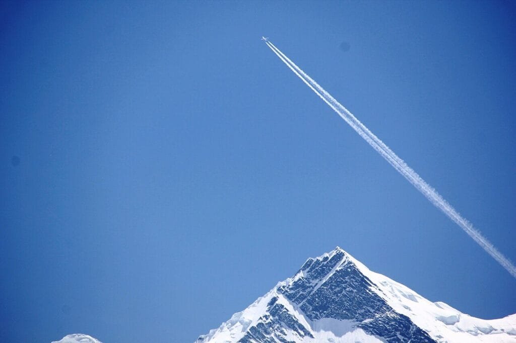 Paraglider soaring over Rakaposhi, captured from Minapin village in Nagar Valley