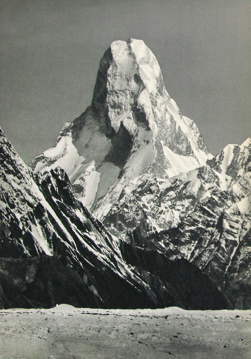 Telephoto view of the Muztagh Tower rising as a sheer rock tooth above Karakoram glaciers