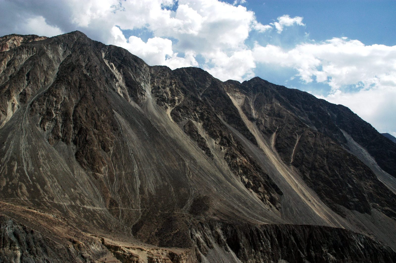 Steep mountain slopes and an alluvial fan enclosing the Bagrot Valley near Gilgit, Pakistan