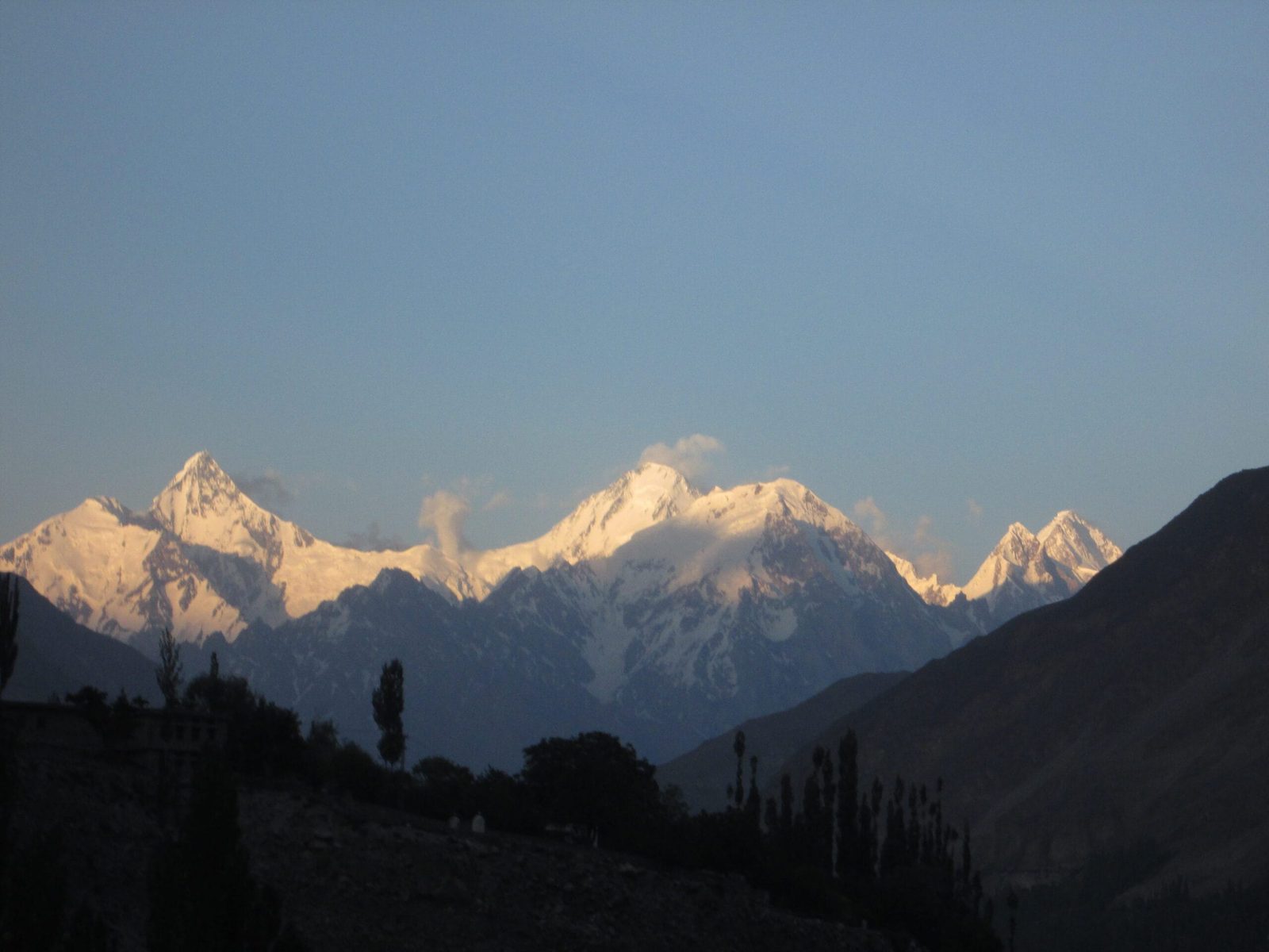 The Hispar Muztagh skyline of Lupghar Sar, Momhil Sar and Trivor from the Karakoram Highway