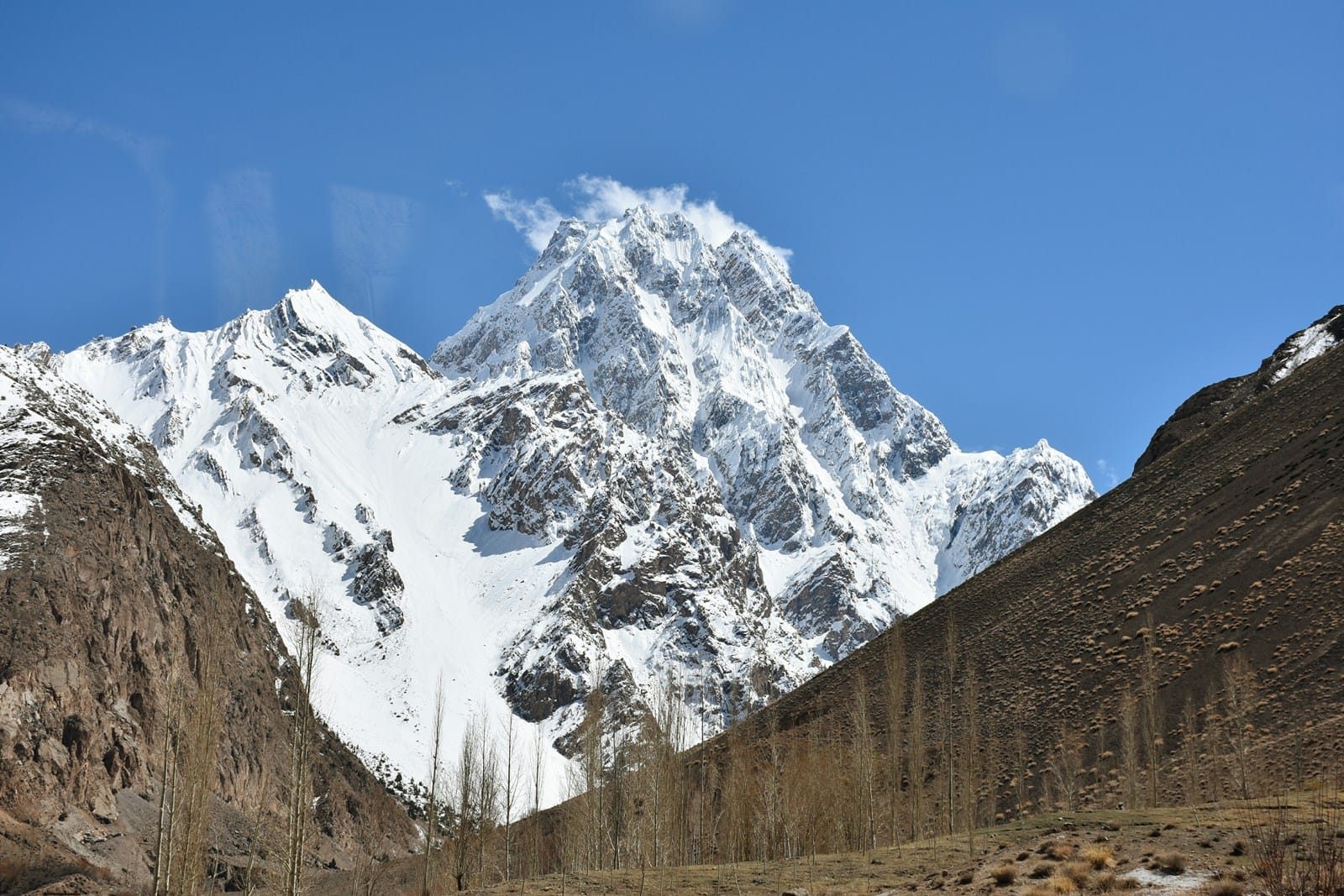 Snow-covered unnamed peak rising above Chapursan Valley in the Karakoram