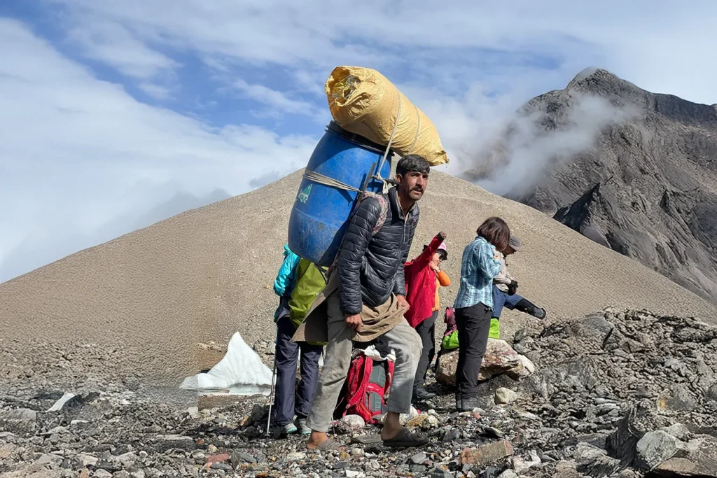 Porter carrying an expedition load on a Karakoram trail