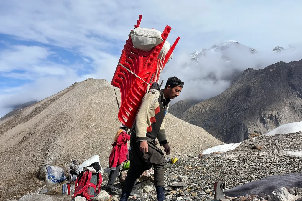 Porter with a wooden load frame at expedition base camp