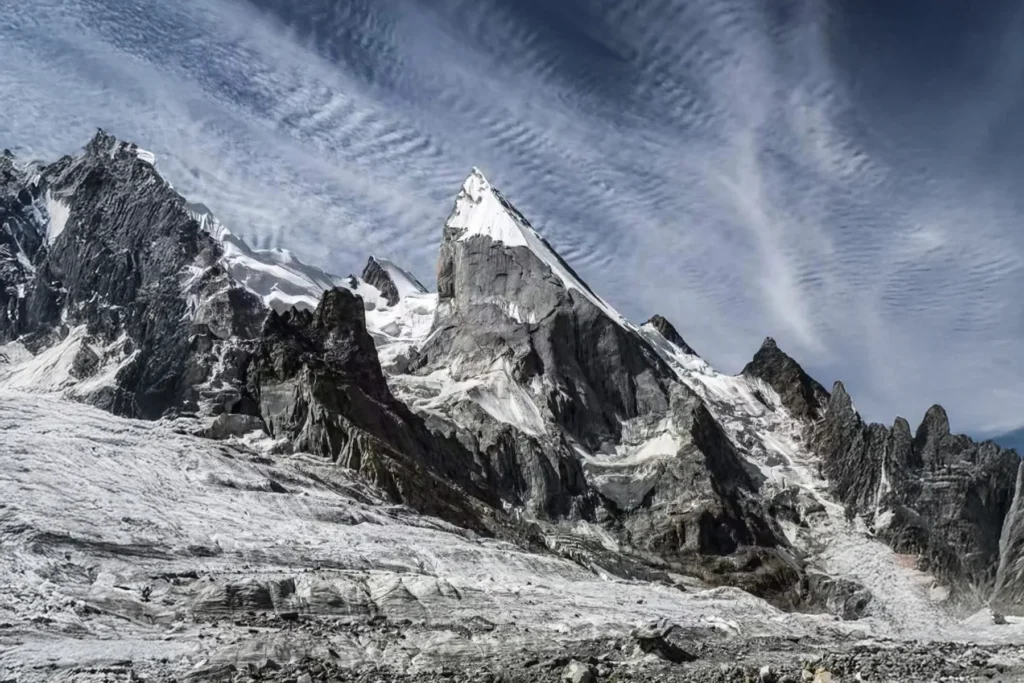 Rock and snow summit crowned by a lenticular cloud