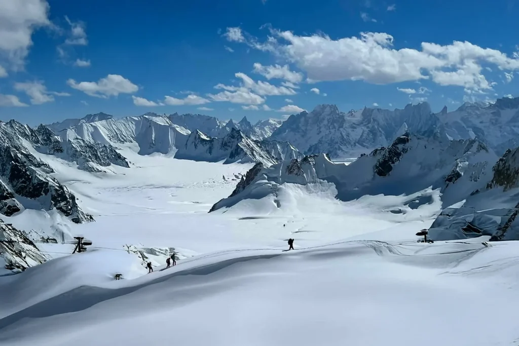 Ski tourers crossing the Snow Lake plateau in the Karakoram