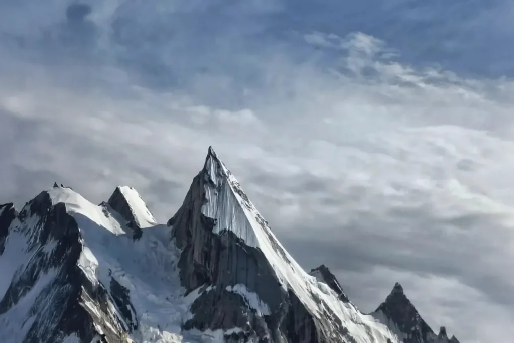 Spearhead-shaped peak under wisps of cirrus cloud